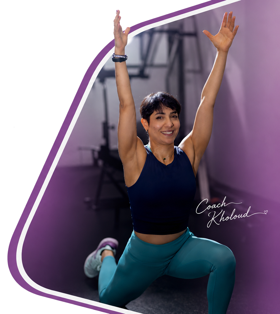 Coach Kholoud Nehme training in her home gym, arms raised mid-stretch.