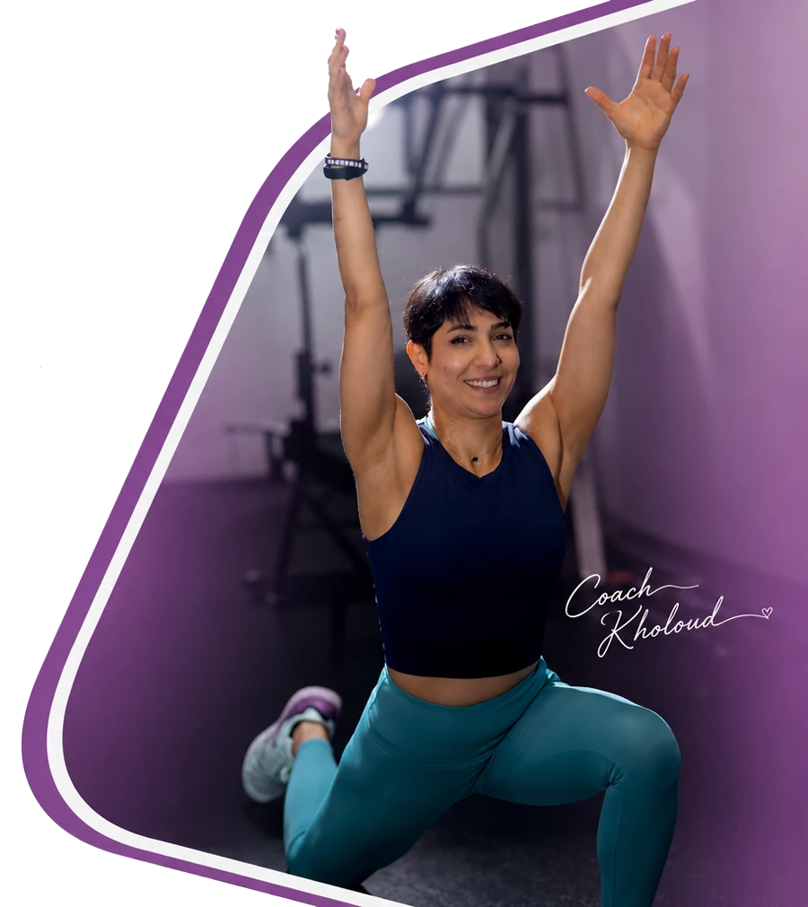 Coach Kholoud Nehme training in her home gym, arms raised mid-stretch.